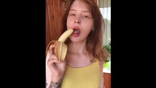 She shows her breasts and eats a banana sexually.
